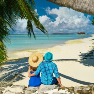 Couple in blue clothes on a beach at Maldives