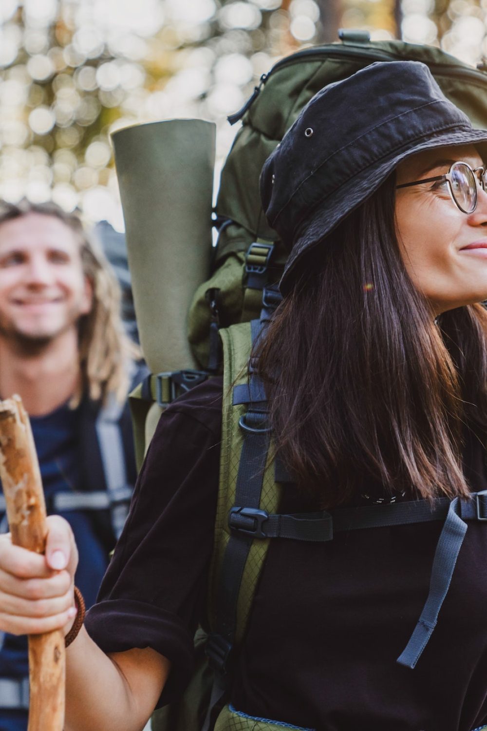 Group of friends trekking while traveling with backpacks walking in forest.