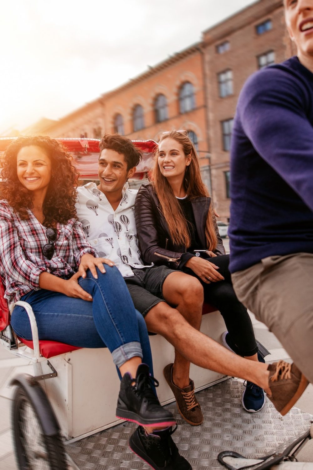 Group of teenagers traveling on tricycle