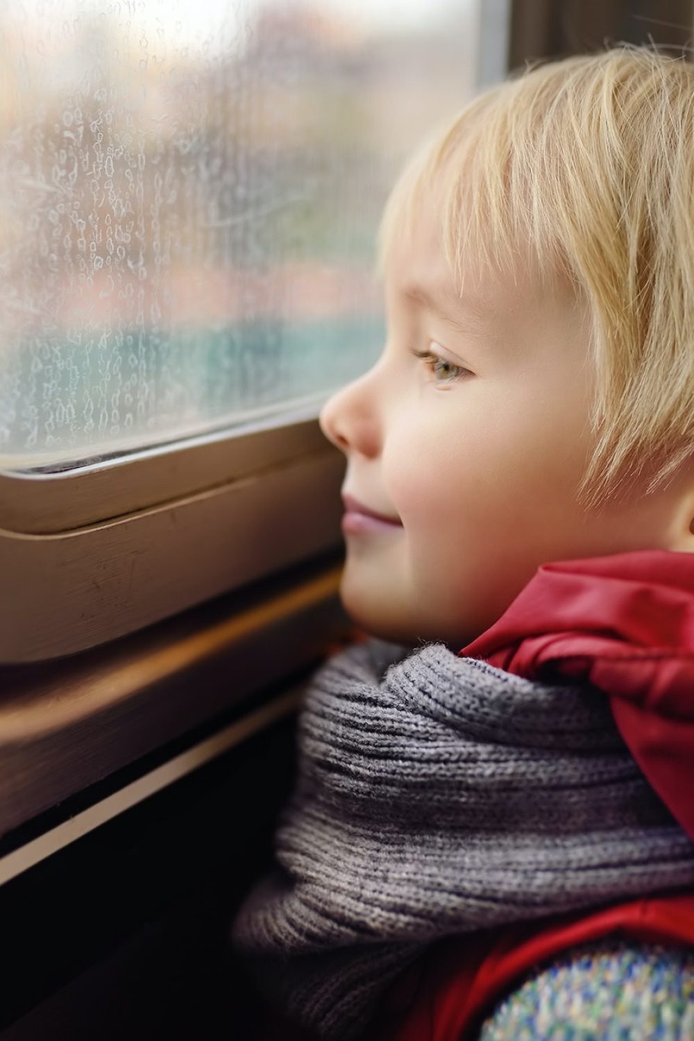 Little boy looks out the window of the car in the subway in New York, USA.